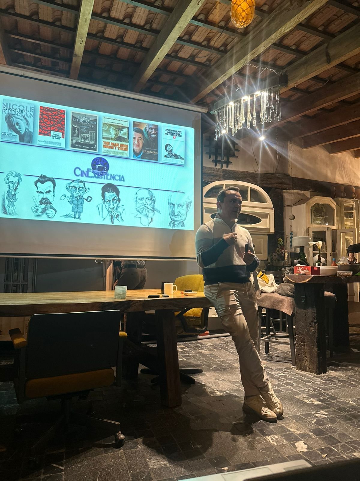 Antonio Araujo durante una sesión de CinExistencia, frente a la pantalla de proyección